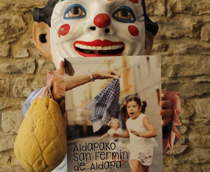 Un kiliki sujeta el cartel de San Fermín de Aldapa de este año.