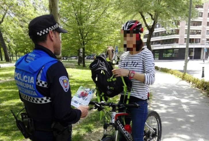 Un agente realiza la prueba de alcoholemia a una ciclista. (AYUNTAMIENTO DE IRUÑEA)